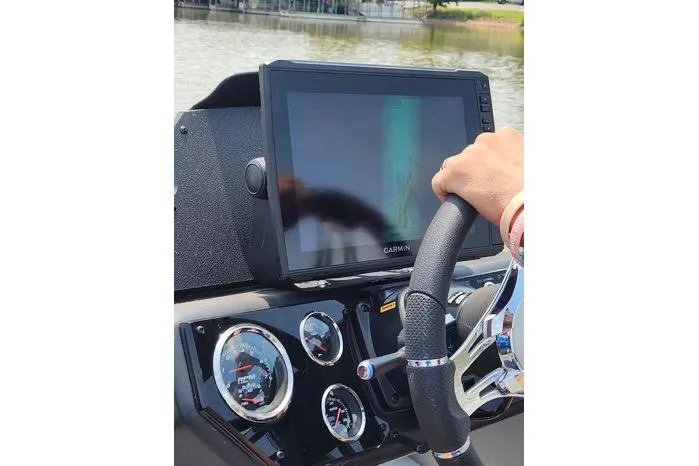 Slide: The Image of 2024 Avid 21 XB Elite boat dashboard with Garmin display and steering wheel. - 4