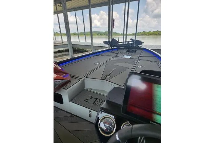 Slide: The Image of 2024 Avid 21 XB Elite boat interior with advanced dashboard and spacious deck. - 5
