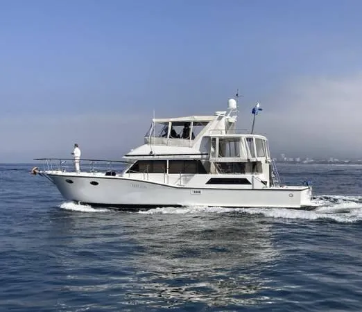 Slide: The Image of 1986 Symbol Yachtfisher cruising on calm ocean waters under a clear sky. - 1