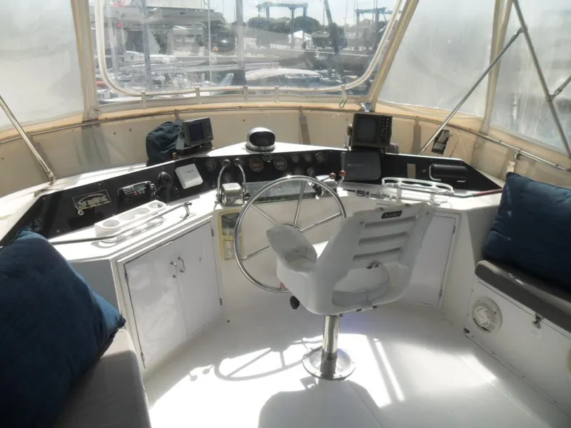 Slide: The Image of 1986 Symbol Yachtfisher helm with steering wheel, navigation equipment, and seating. - 27