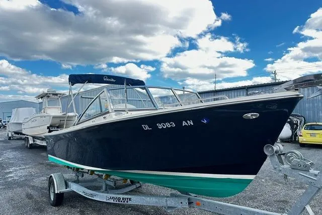 The Image of 2022 Rossiter R23 Picnic Boat on trailer under blue sky. - 0