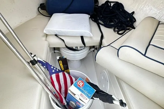 Slide: The Image of 2022 Rossiter R23 Picnic Boat interior with American flag, cushions, and nautical equipment. - 15