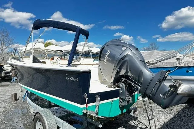 Slide: The Image of 2022 Rossiter R23 Picnic Boat with Yamaha engine on trailer under blue sky. - 2