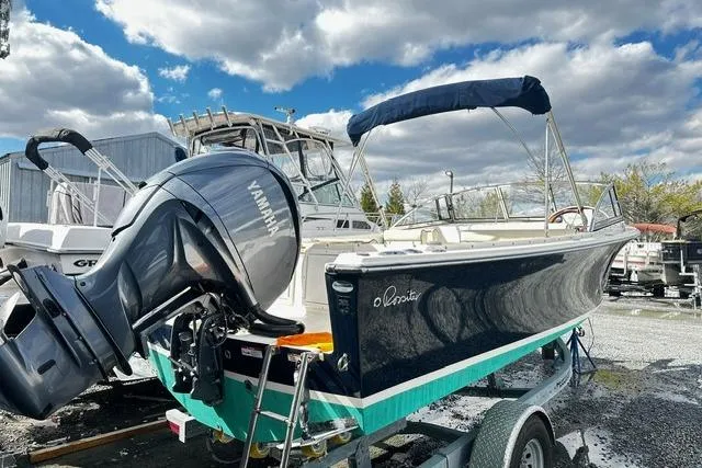 Slide: The Image of 2022 Rossiter R23 Picnic Boat with Yamaha engine on trailer under cloudy sky. - 3