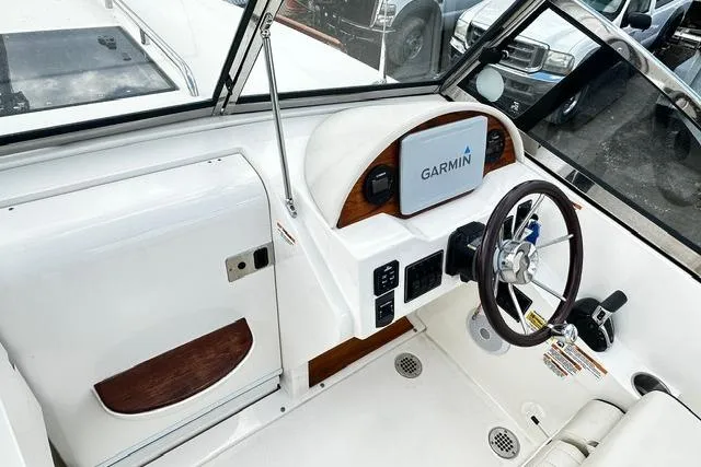 Slide: The Image of 2022 Rossiter R23 Picnic Boat cockpit with Garmin navigation system and sleek steering wheel. - 8