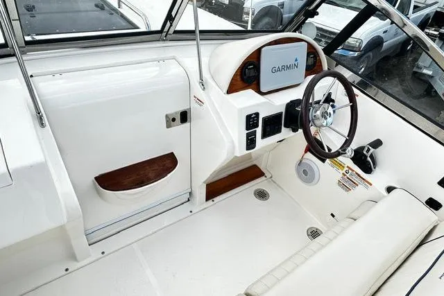 Slide: The Image of 2022 Rossiter R23 Picnic Boat interior with Garmin navigation system and sleek white design. - 9