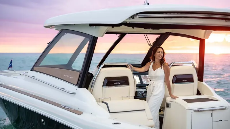 Slide: The Image of Woman on Chris-Craft Calypso 35 boat at sunset, 2026 model. - 14
