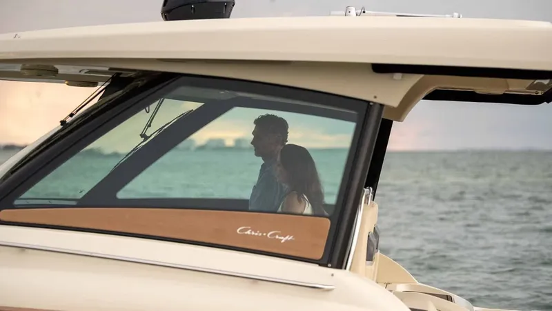 Slide: The Image of 2026 Chris-Craft Calypso 35 on water with two people. - 4