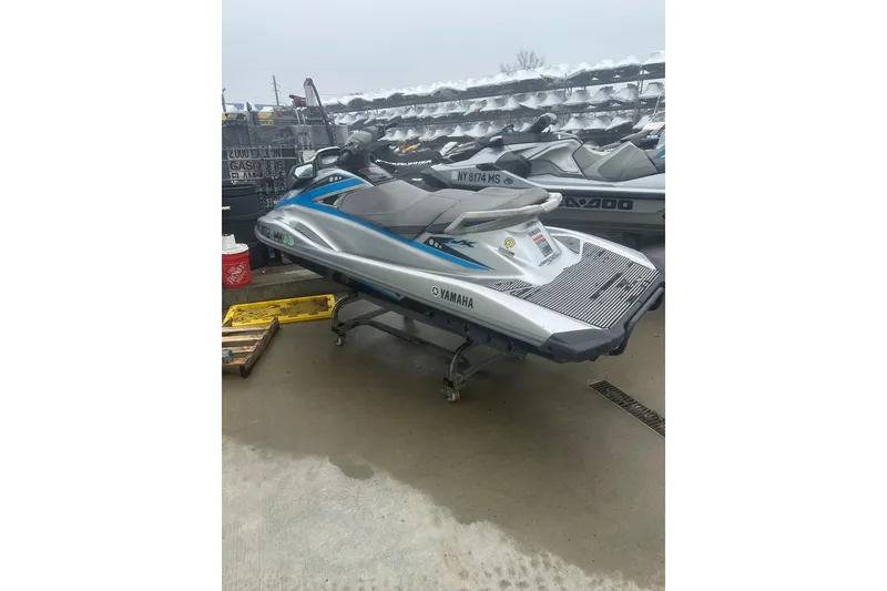 Slide: The Image of 2015 Yamaha WaveRunner VX Deluxe jet ski in storage, silver and blue design. - 7