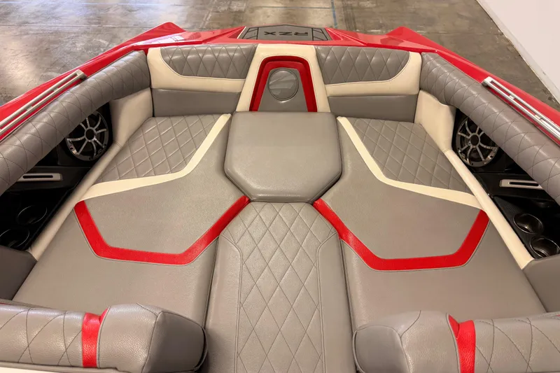 Slide: The Image of 2018 Tigé RZX2 boat interior with red and gray diamond-stitched upholstery. - 10