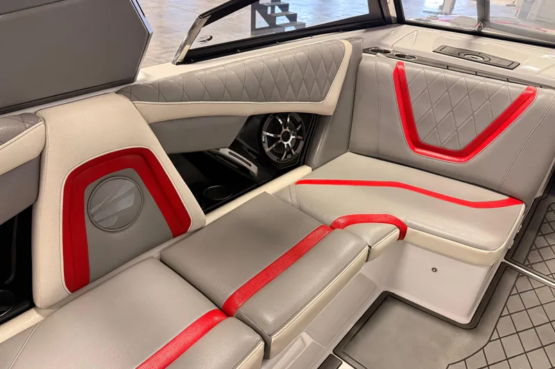 Slide: The Image of 2018 Tigé RZX2 boat interior with gray and red upholstery, featuring stylish seating and speaker system. - 7