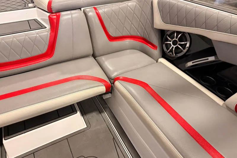 Slide: The Image of 2018 Tigé RZX2 boat interior with gray and red upholstery, featuring a speaker. - 8