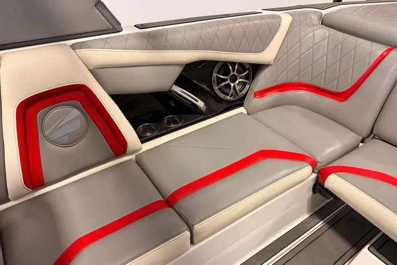 Slide: The Image of 2018 Tigé RZX2 boat interior with gray and red upholstery, featuring a speaker and cup holders. - 9