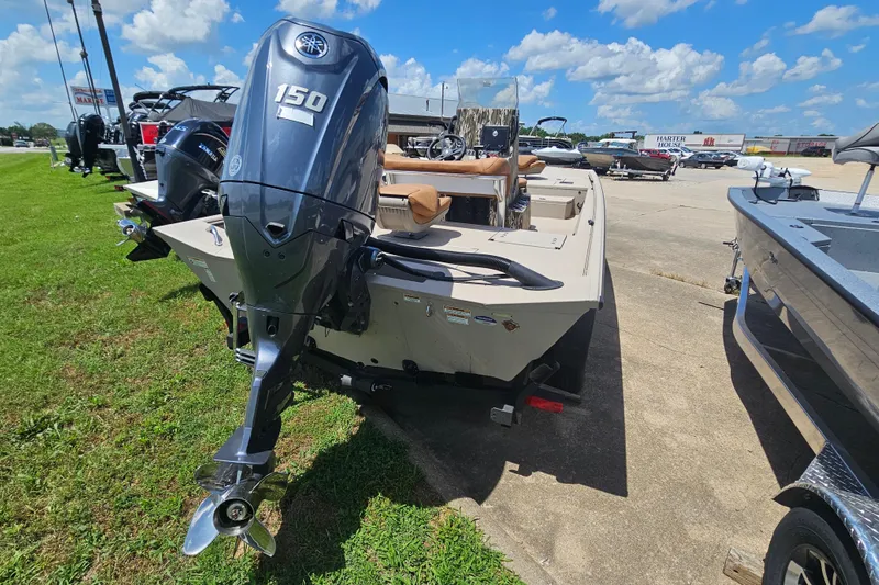 Slide: The Image of 2024 Avid 20 Rogue CC boat with Yamaha 150 engine, parked outdoors. - 5