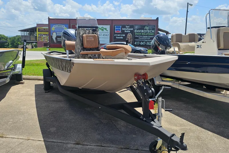 Slide: The Image of 2024 Avid 20 Rogue CC boat on trailer, displayed outdoors under a sunny sky. - 6