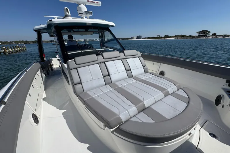 Slide: The Image of 2021 Boston Whaler 420 Outrage boat with luxurious seating on calm waters. - 11