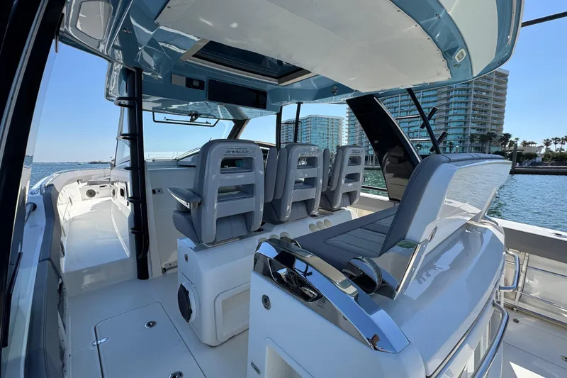 Slide: The Image of 2021 Boston Whaler 420 Outrage boat interior with modern seating and ocean view. - 12