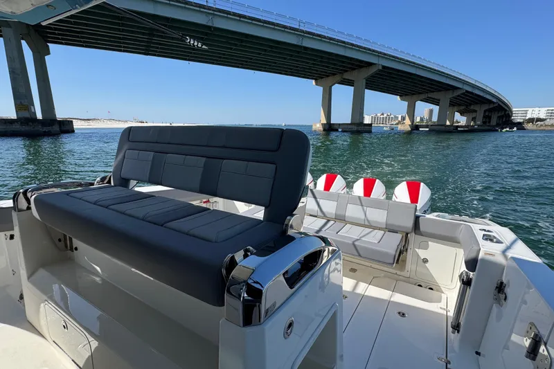 Slide: The Image of 2021 Boston Whaler 420 Outrage boat under a bridge on a sunny day. - 13