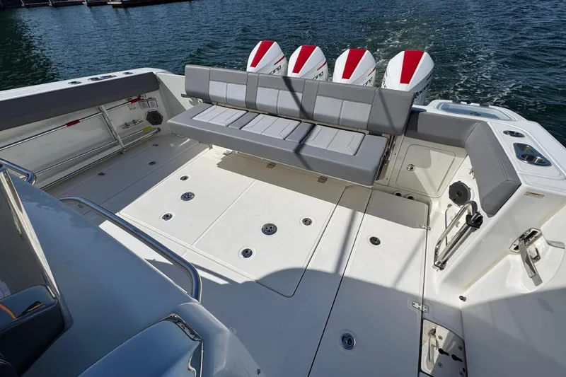 Slide: The Image of 2021 Boston Whaler 420 Outrage boat deck with seating and four outboard engines. - 14