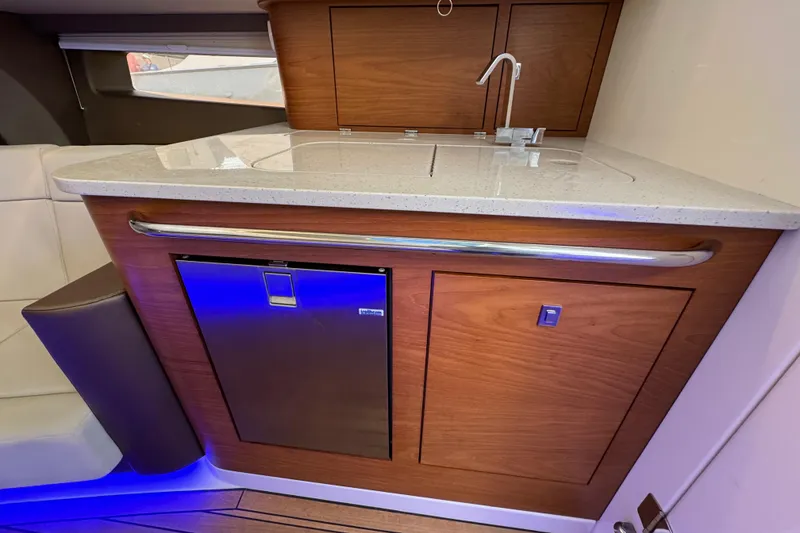 Slide: The Image of Luxurious interior of 2021 Boston Whaler 420 Outrage with modern kitchenette and sleek design. - 19