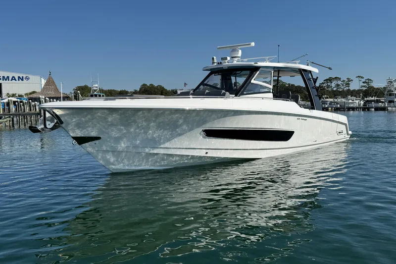 Slide: The Image of 2021 Boston Whaler 420 Outrage boat on calm water, clear sky background. - 2
