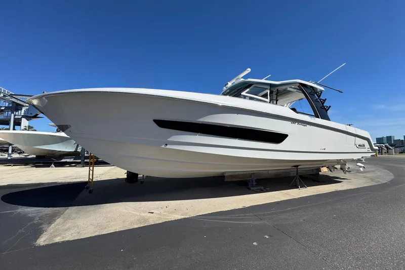 Slide: The Image of 2021 Boston Whaler 420 Outrage boat on display under clear blue sky. - 3