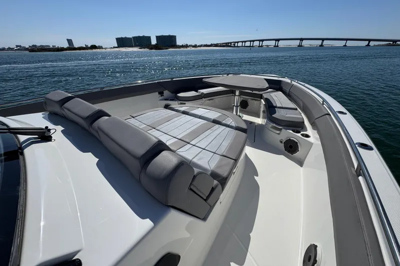 Slide: The Image of 2021 Boston Whaler 420 Outrage boat interior with seating and table on calm water. - 8