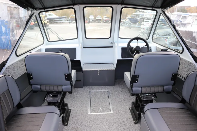 Slide: The Image of 2026 Alumaweld Intruder Outboard 22 boat interior storage compartment with open hatch. - 17