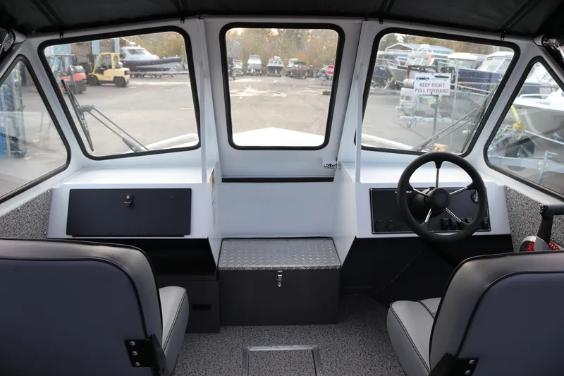 Slide: The Image of Interior of 2026 Alumaweld Intruder Outboard 22 boat, featuring dashboard and storage compartment. - 18
