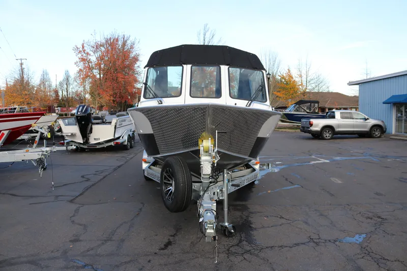 Slide: The Image of Interior view of 2026 Alumaweld Intruder Outboard 22 boat, featuring seating and windows. - 6