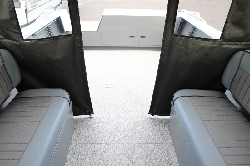 Slide: The Image of Interior view of 2026 Alumaweld Intruder Outboard 22 boat with gray seating. - 10