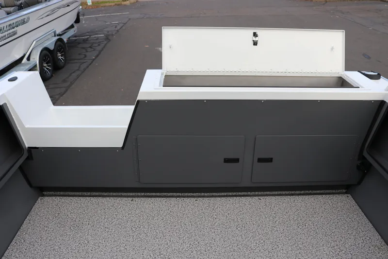 Slide: The Image of 2026 Alumaweld Intruder Outboard 22 boat interior with storage compartments and open hatch. - 13