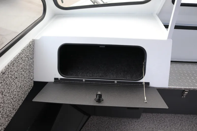 Slide: The Image of 2026 Alumaweld Intruder Outboard 22 boat interior storage compartment with open hatch. - 20
