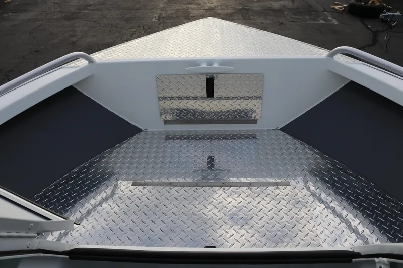 Slide: The Image of 2026 Alumaweld Intruder Outboard 22 boat with diamond plate flooring and spacious bow area. - 31