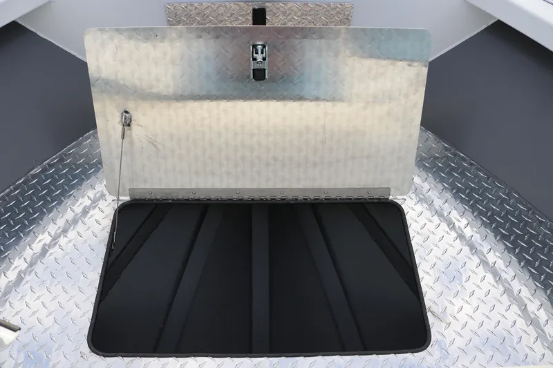 Slide: The Image of 2026 Alumaweld Intruder Outboard 22 boat storage compartment with diamond plate flooring. - 33