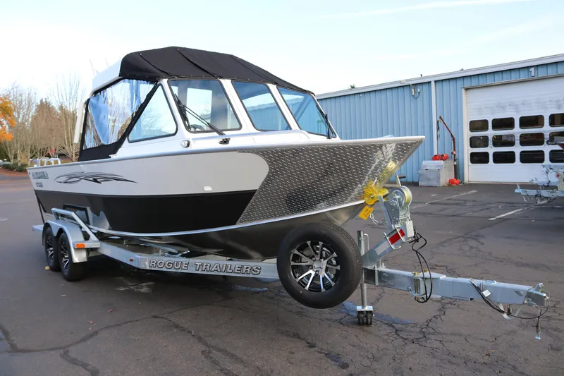 Slide: The Image of 2026 Alumaweld Intruder Outboard 22 boat on Rogue trailer in parking lot. - 5
