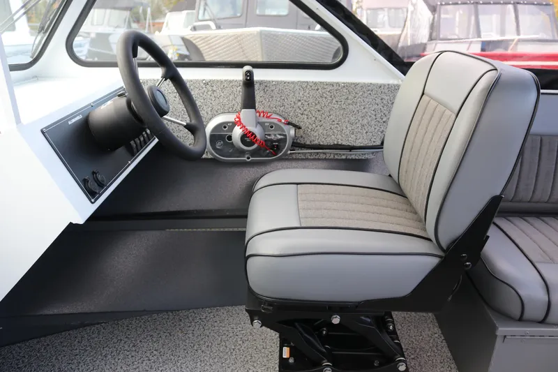 Slide: The Image of 2026 Alumaweld Intruder Outboard 22 interior with steering wheel and cushioned seat. - 9