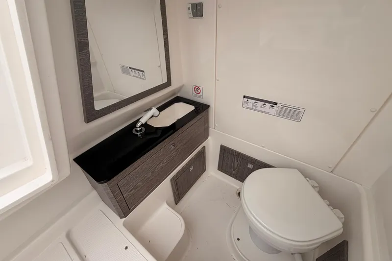 Slide: The Image of Compact bathroom in 2022 Zar 79SL boat with sink, mirror, and toilet. - 16