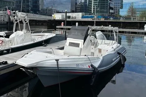 Slide: The Image of 2022 Zar 79SL boat docked at a marina with modern buildings in the background. - 3