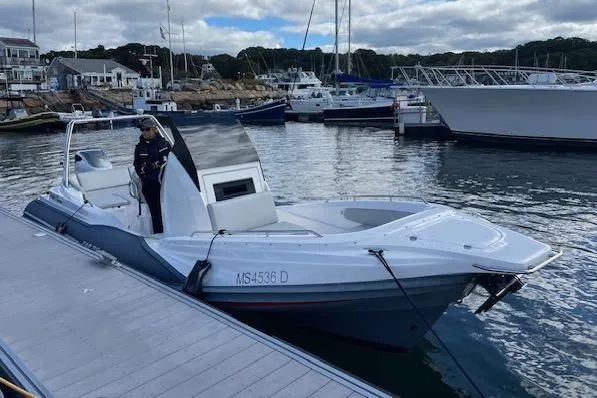 Slide: The Image of 2022 Zar 79SL boat docked at marina with person onboard, surrounded by other vessels. - 4