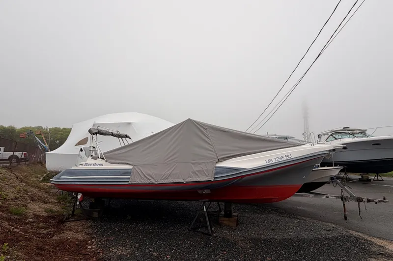 Slide: The Image of 2022 Zar 79SL boat covered, parked on gravel, with foggy background. - 7