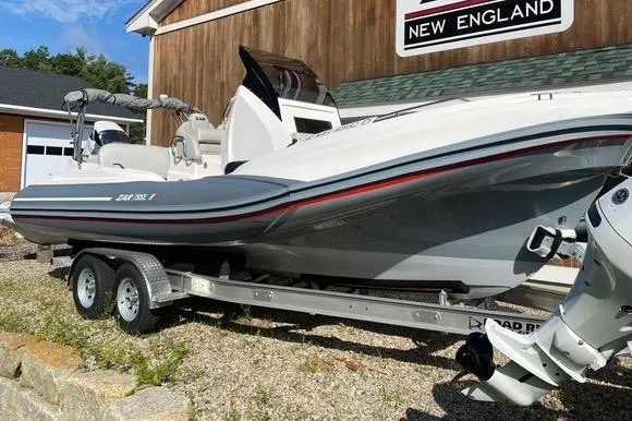 Slide: The Image of 2022 Zar 79SL boat on trailer, parked outdoors near a wooden building. - 8