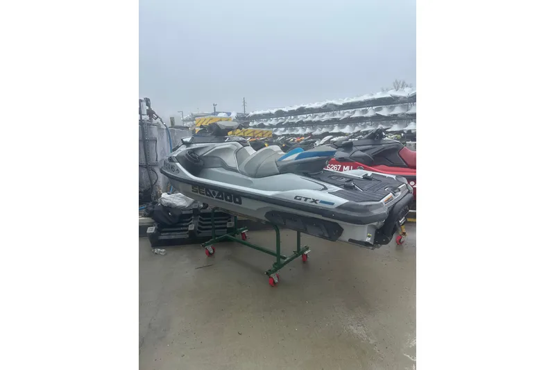 Slide: The Image of 2021 Sea-Doo GTX Limited 300 jet ski on display in outdoor storage area. - 8