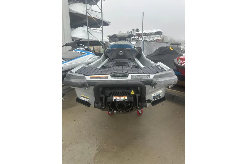 Slide: The Image of 2021 Sea-Doo GTX Limited 300 jet ski, rear view, parked on concrete. - 9