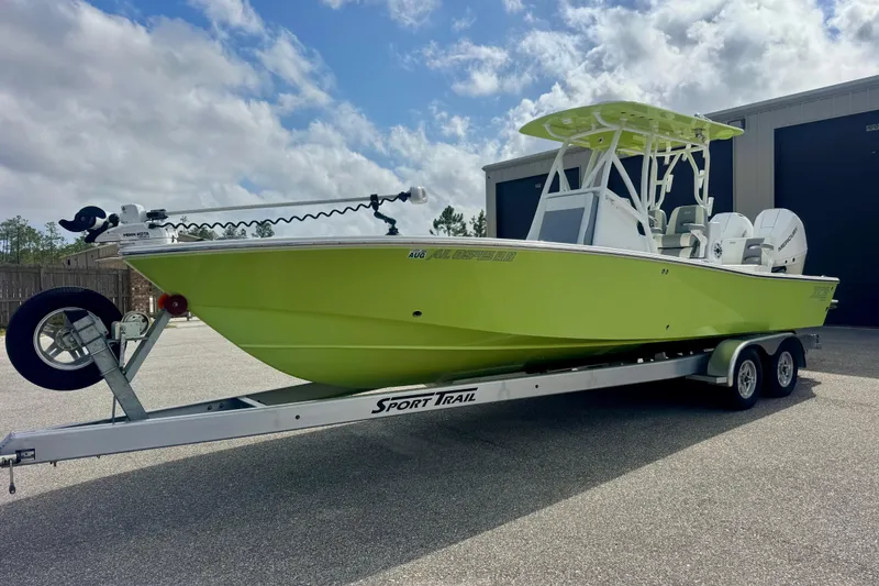 The Image of 2023 ZCB Freemason 26 boat on trailer, lime green hull, parked outdoors. - 1