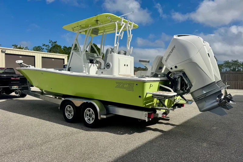 Slide: The Image of 2023 ZCB Freemason 26 boat with Mercury engine on trailer, lime green hull. - 3