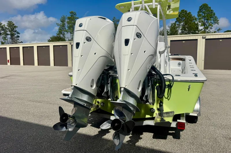 Slide: The Image of Twin outboard engines on a 2023 ZCB Freemason 26 boat, parked near storage units. - 5