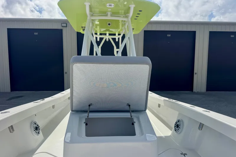 Slide: The Image of 2023 ZCB Freemason 26 boat with open storage compartment, docked near storage units. - 7