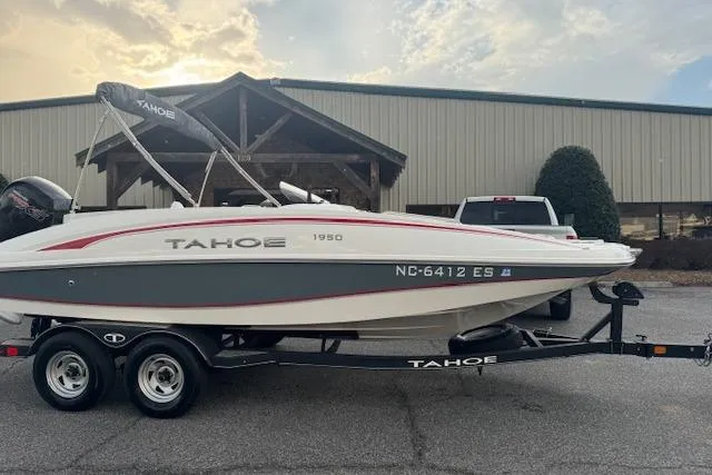 The Image of Tahoe 1950 boat on trailer, 2018 model, parked outdoors near a building. - 1