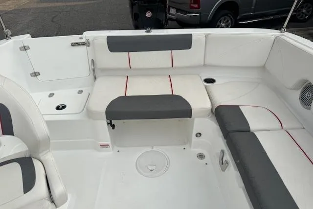 Slide: The Image of Interior of a 2018 Tahoe 1950 boat with white and gray seating. - 10